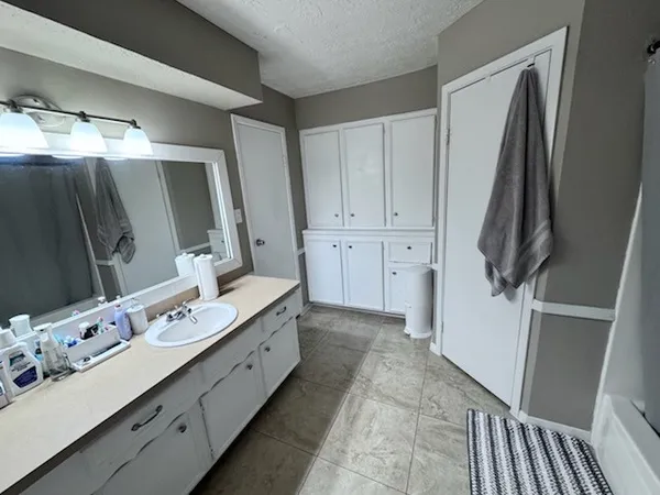 a bathroom with a double vanity sink and mirror