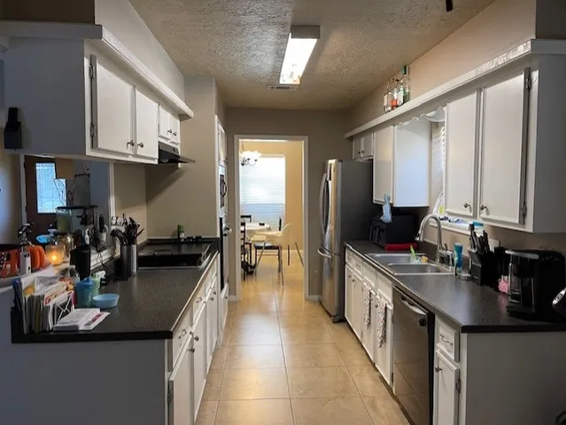 a kitchen with sink stove and cabinets