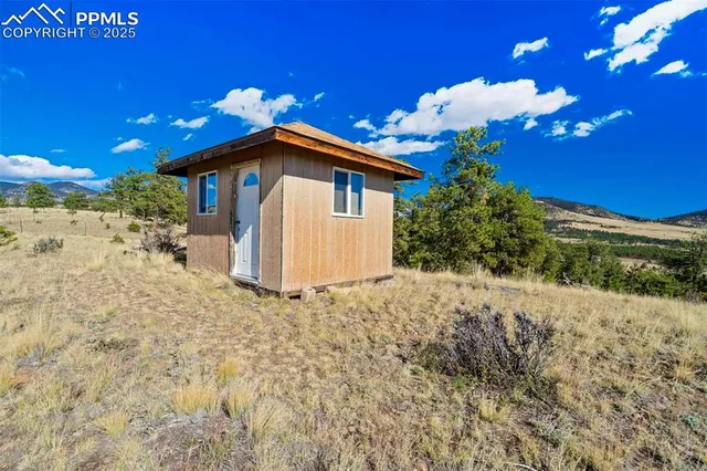 a yellow house with a flower garden