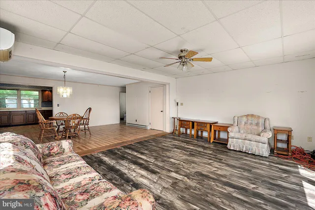 a living room with furniture and a large window with outer view