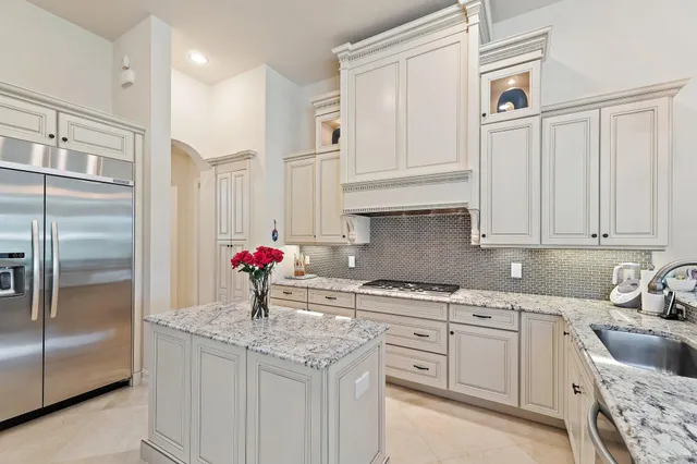 a bathroom with a stove a sink and a shower curtain