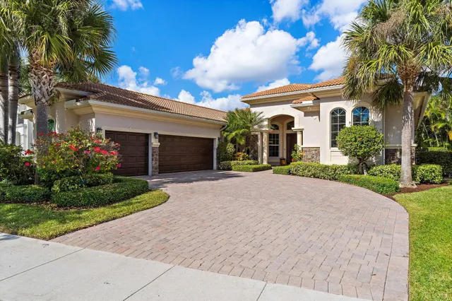 a bedroom with bed a flat tv screen and a dresser