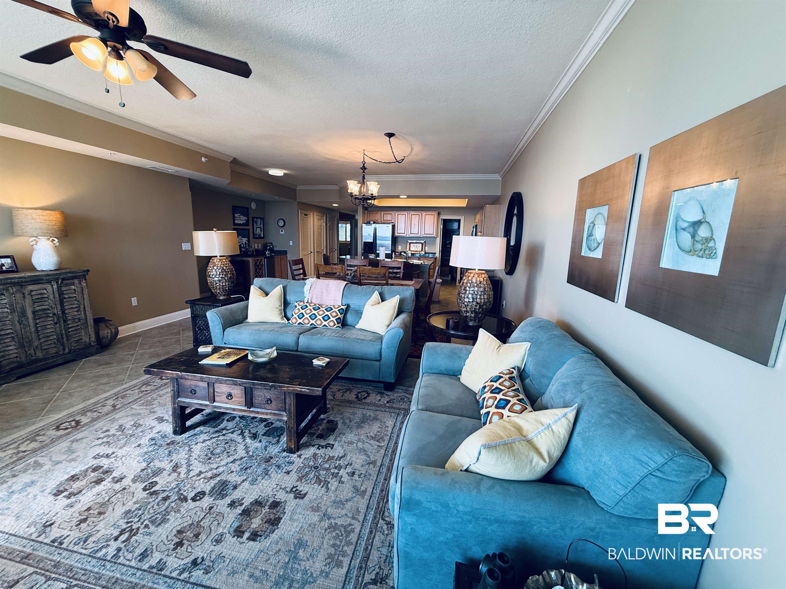 27800 Canal Road, Unit 409 Orange Beach, AL 36561 - Photo 14 of 22 Living area featuring a textured ceiling, a ceiling fan, crown molding, suspended lighting, and tile patterned floors