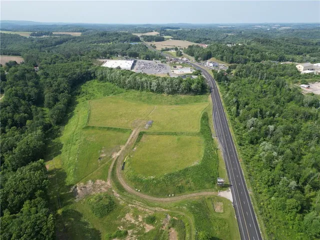 an aerial view of residential houses with outdoor space and river