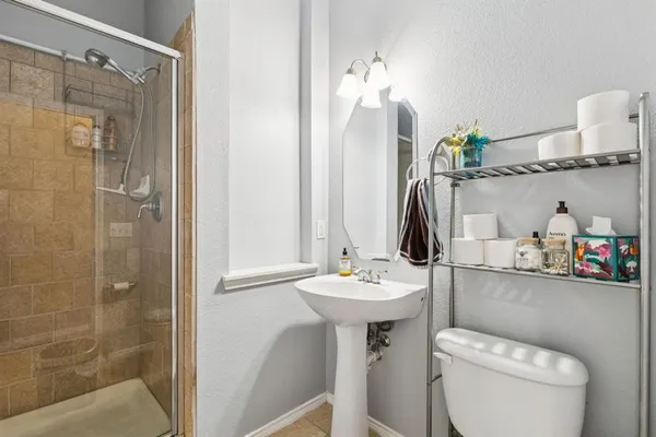 a bathroom with a sink toilet and shower