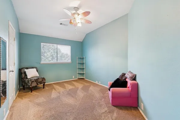 a bedroom with bed and a chandelier
