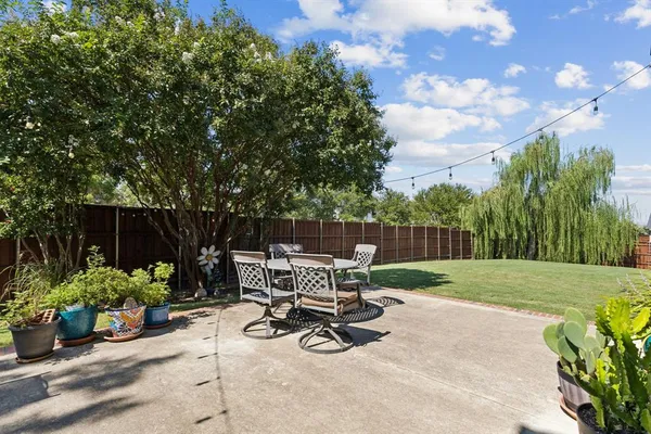 a view of backyard with seating space and trees