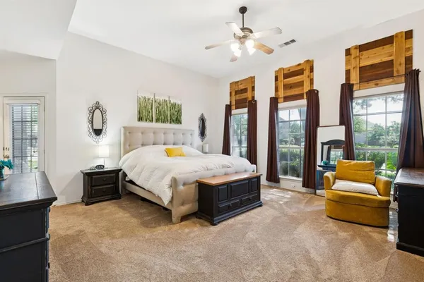 a spacious bedroom with a bed and a couch