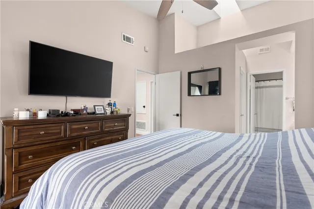 a bedroom with a bed and a flat screen tv