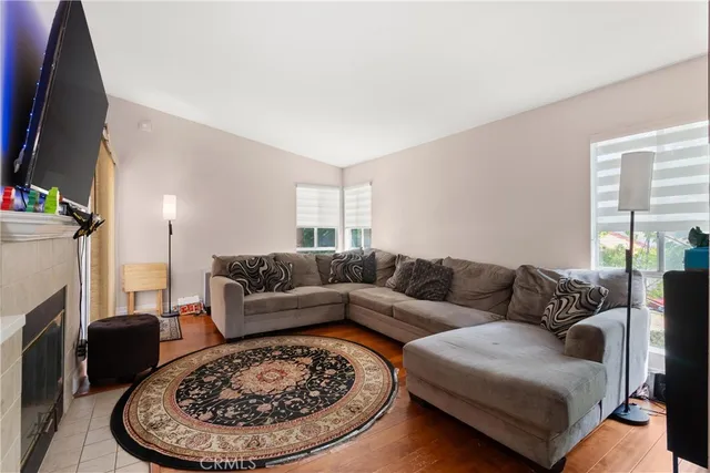 a living room with furniture a fireplace and a flat screen tv
