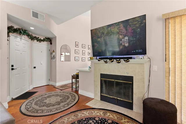 a living room with furniture a flat screen tv and a fireplace