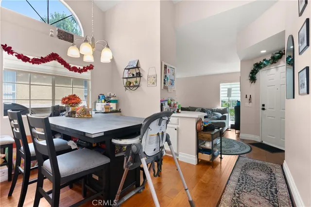 a view of a dining room with furniture and a chandelier