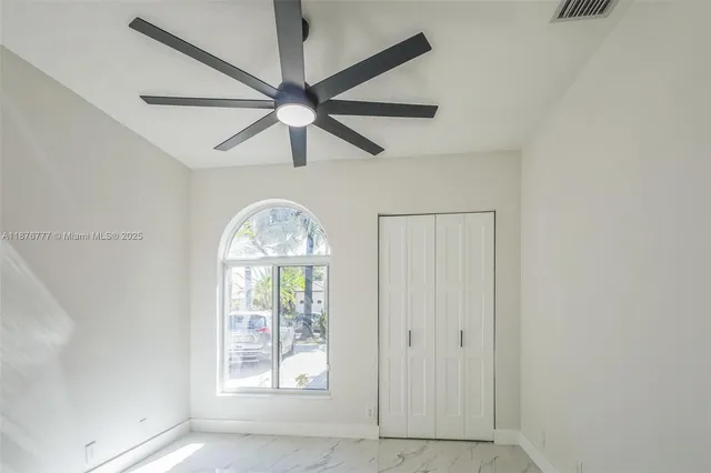 an empty room with windows and front door