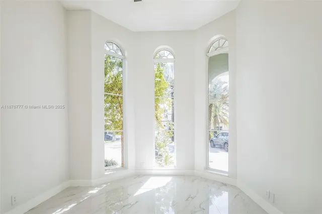 a view of a livingroom with wooden floor and a window