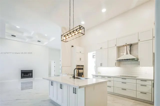 a kitchen with cabinets and wooden floor