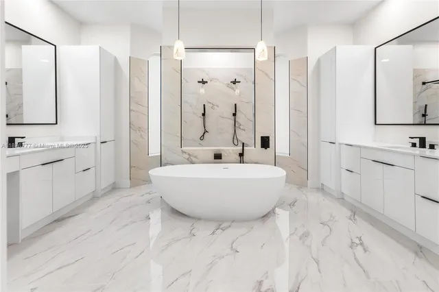 a bathroom with a tub sink shower and mirror