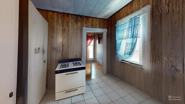a kitchen with a refrigerator and window