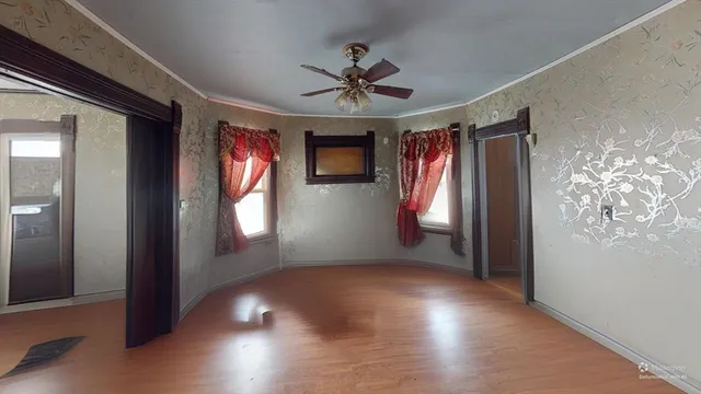 wooden floor in an empty room with a window