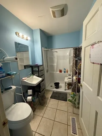 a bathroom with a sink toilet and shower