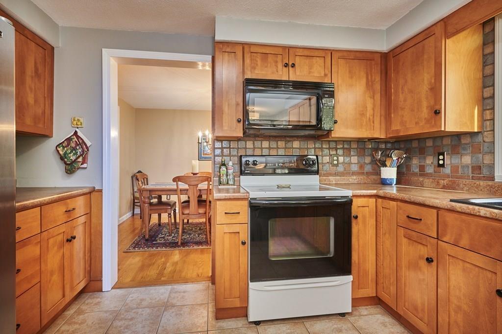 302 Loudville Road Easthampton, MA 01027 - Photo 8 of 34 a kitchen with stainless steel appliances granite countertop a stove a sink and a microwave