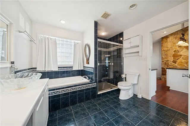 a bathroom with a toilet a sink and mirror