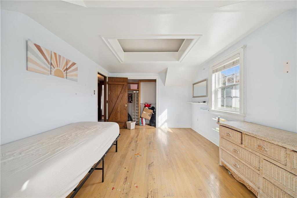 1512 Abers Creek Road Pittsburgh, PA 15239 - Photo 21 of 45 a bedroom with a bed and wooden floor