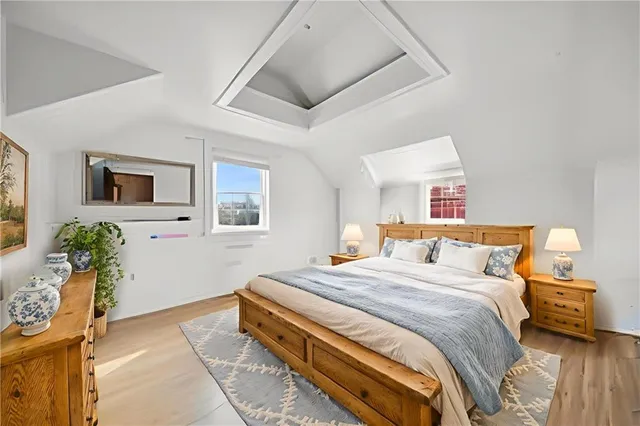 a bedroom with a bed and wooden floor