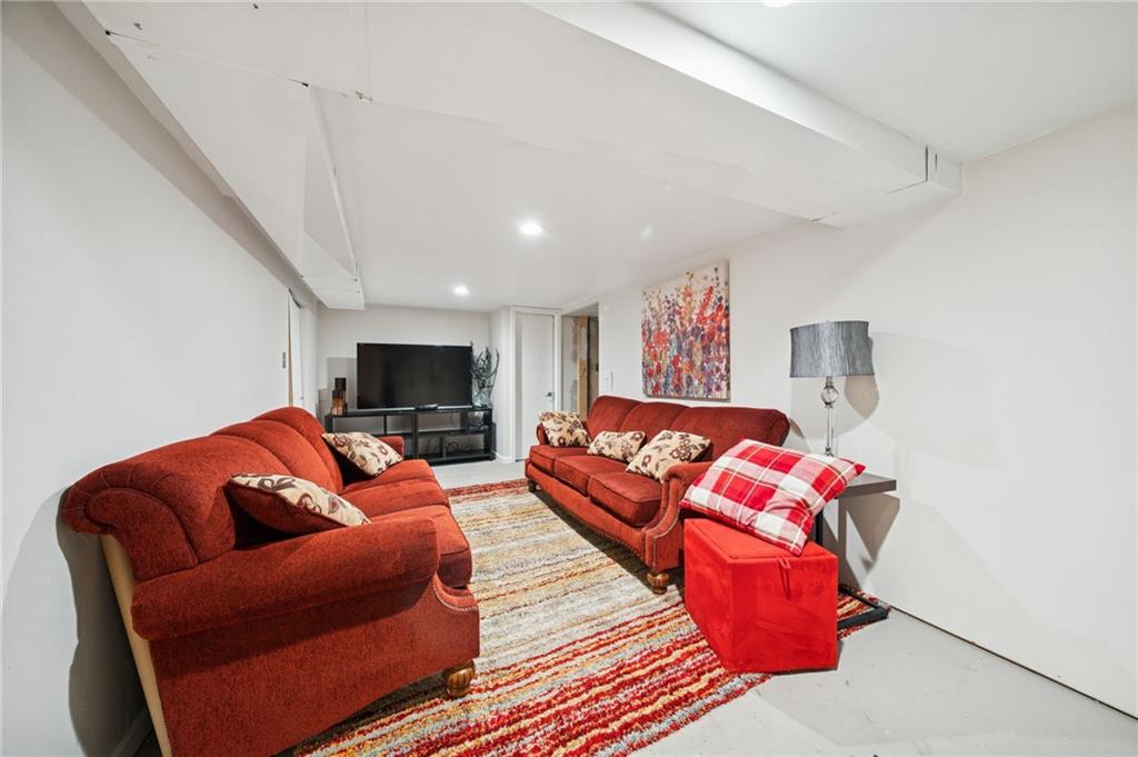 1512 Abers Creek Road Pittsburgh, PA 15239 - Photo 31 of 45 a living room with furniture a flat screen tv and a couch