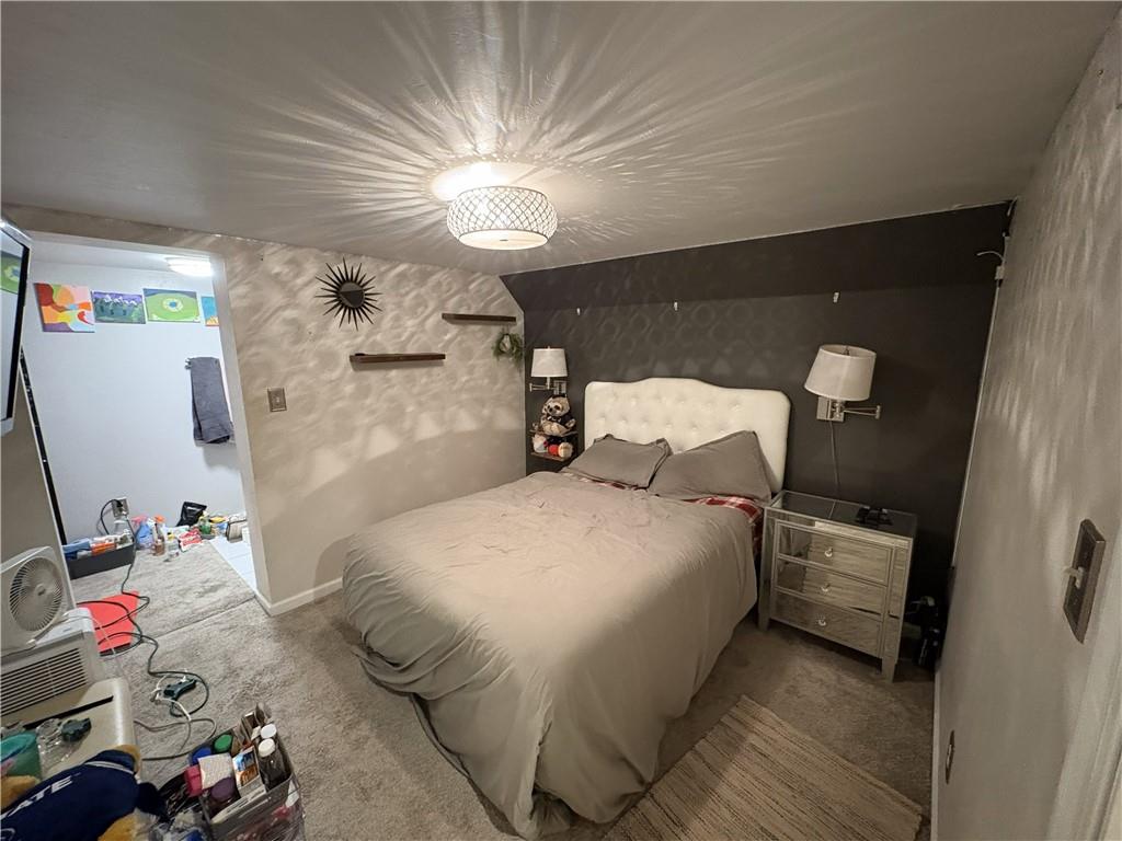 1512 Abers Creek Road Pittsburgh, PA 15239 - Photo 32 of 45 a bedroom with a bed and a chandelier