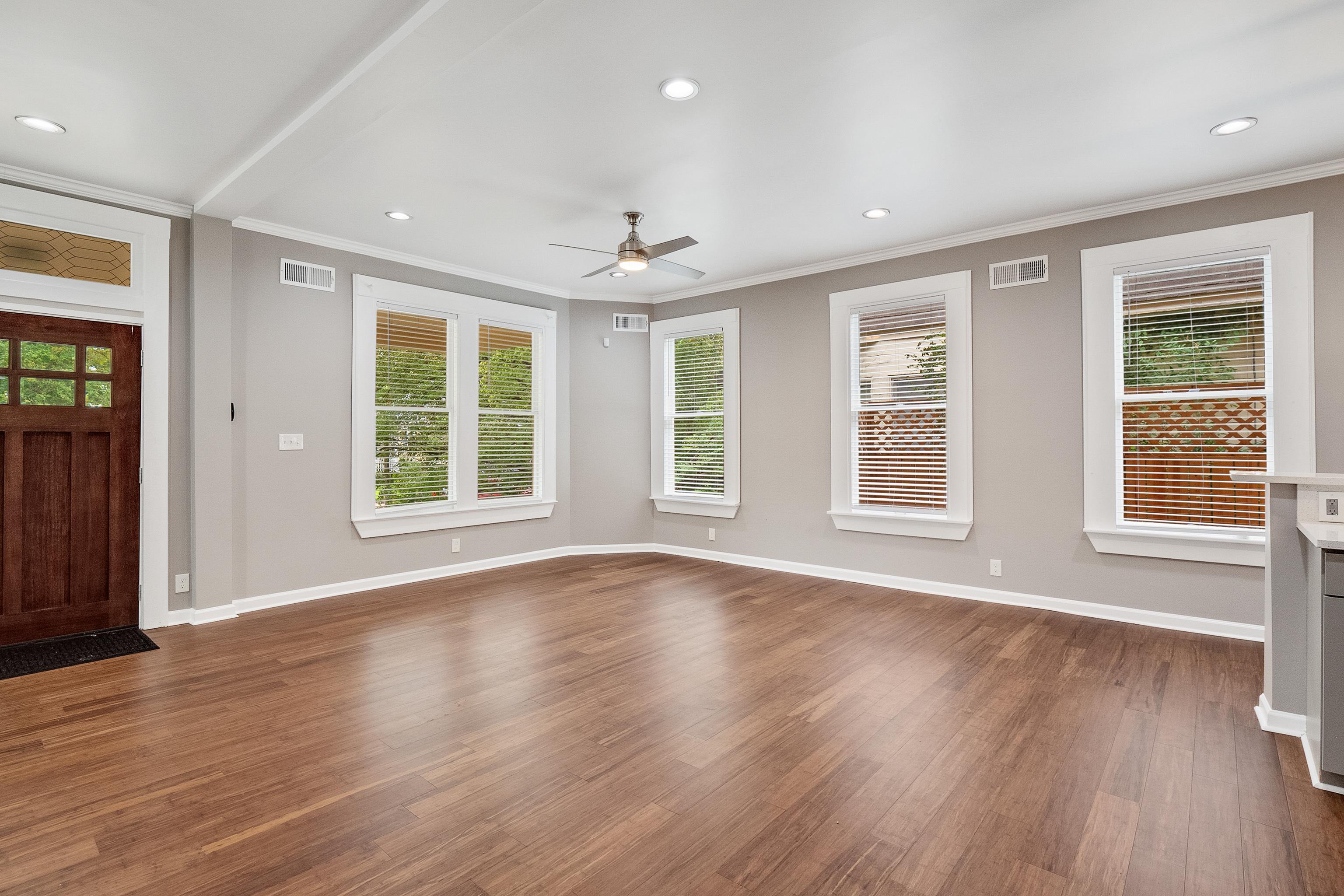 1663 Lawrence Avenue Memphis, TN 38112 - Photo 5 of 37 a view of an empty room with wooden floor and a window