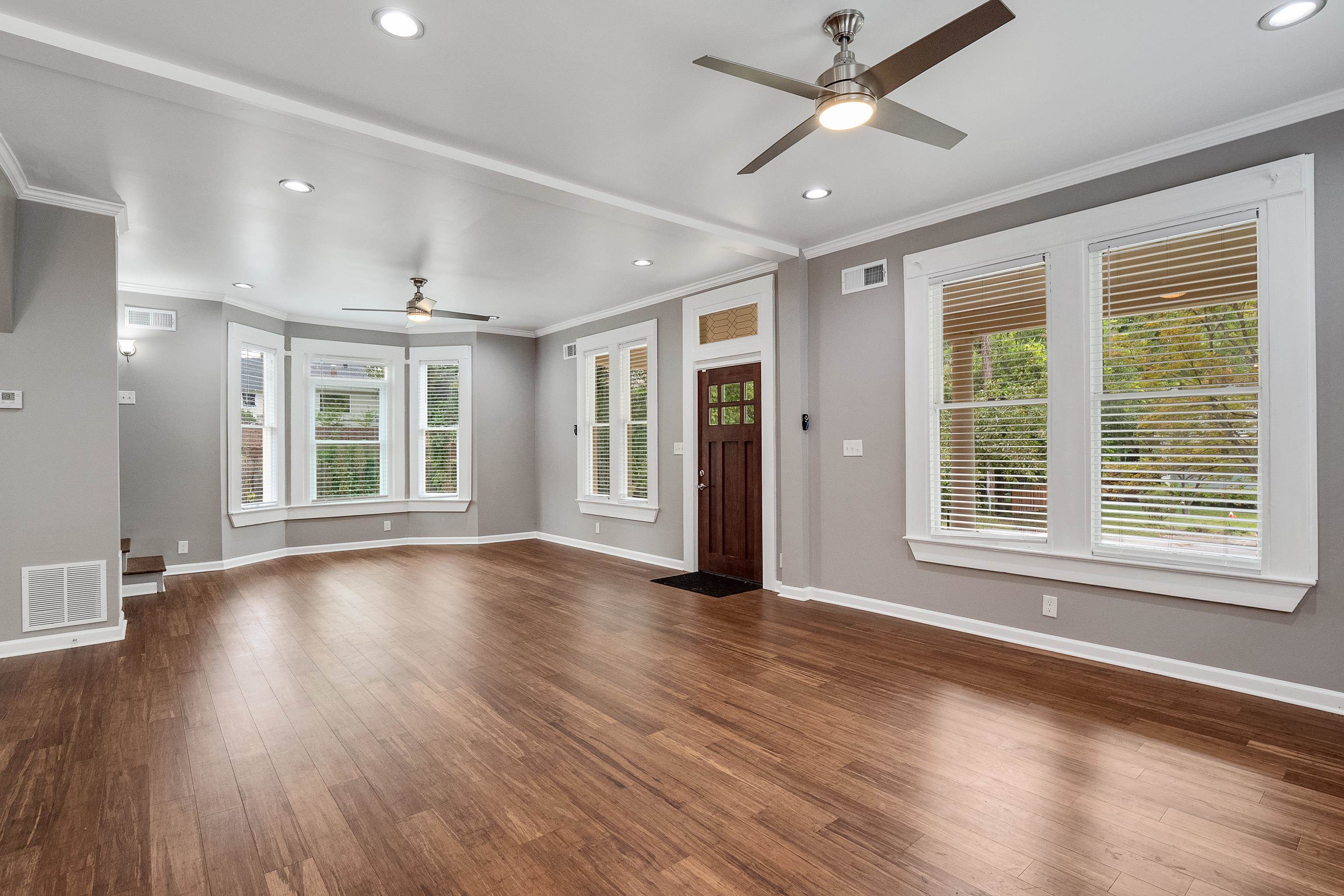 1663 Lawrence Avenue Memphis, TN 38112 - Photo 8 of 37 a view of an empty room with wooden floor and a window