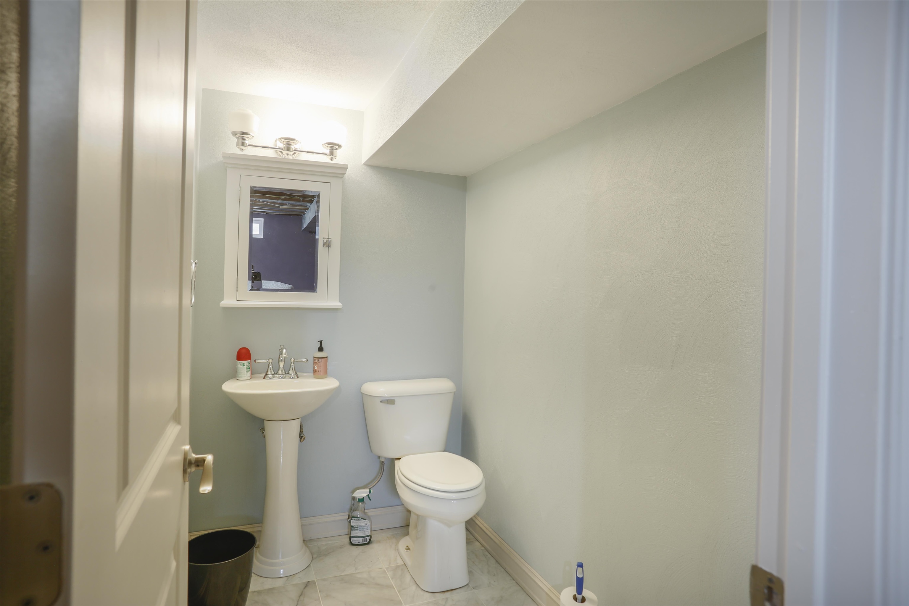 616 Davis Street Davis, IL 61019 - Photo 13 of 14 a bathroom with a toilet sink and mirror