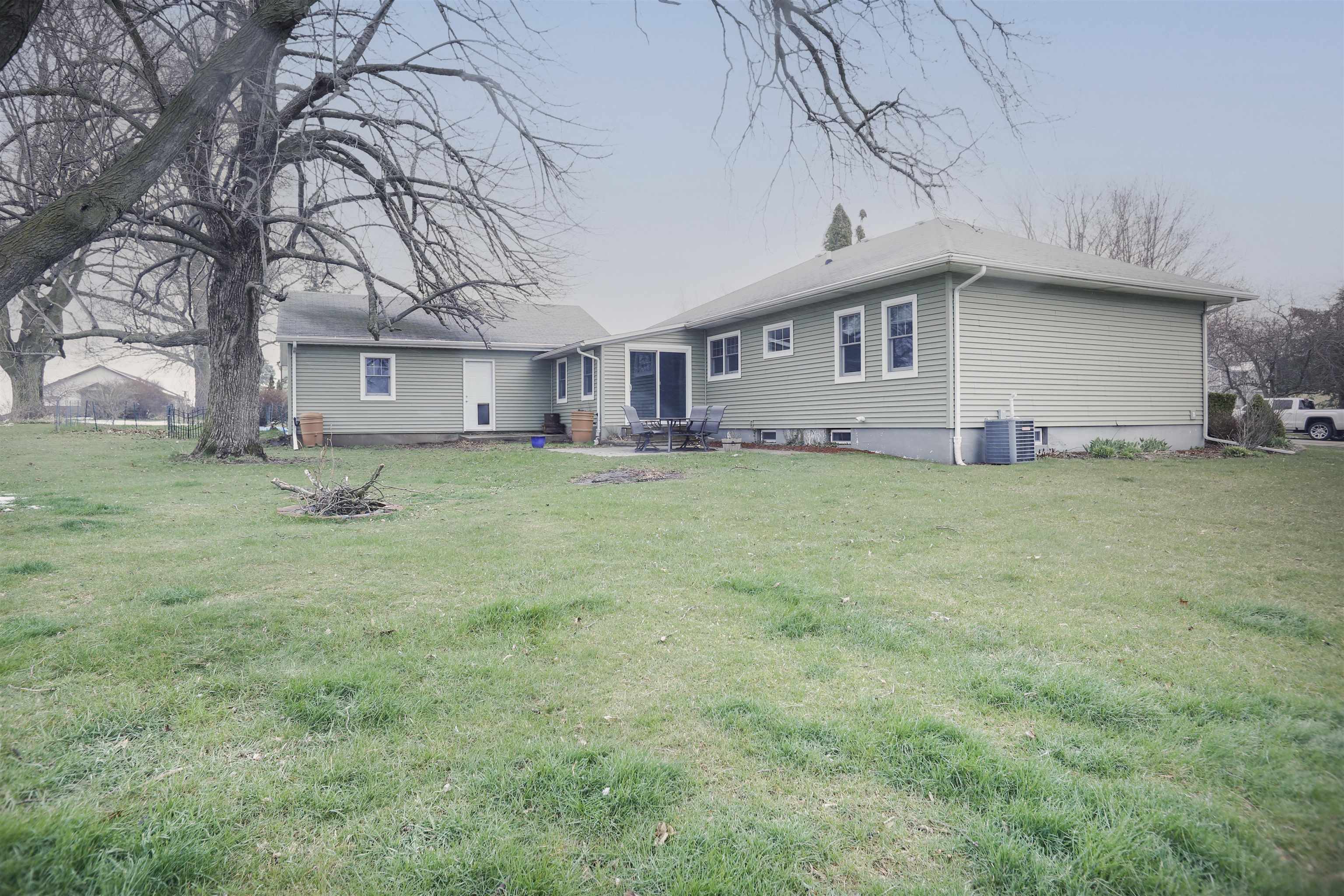 616 Davis Street Davis, IL 61019 - Photo 14 of 14 a house that is sitting in the grass with large trees