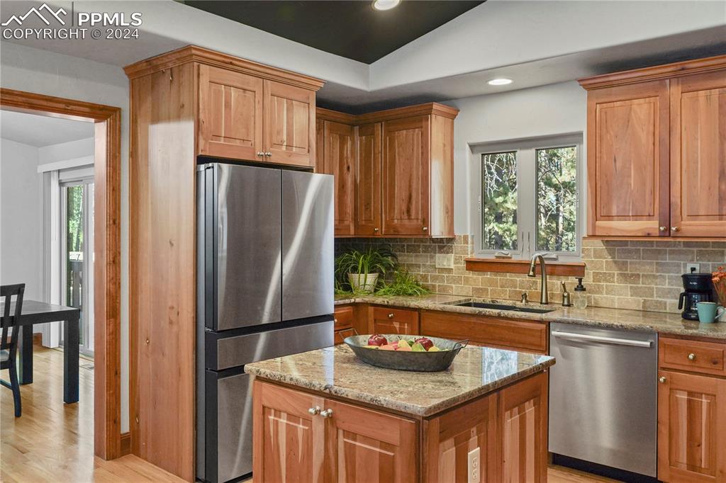 9450 Morgan Road Colorado Springs, CO 80908 - Photo 18 of 49 a kitchen with stainless steel appliances granite countertop a refrigerator sink and cabinets