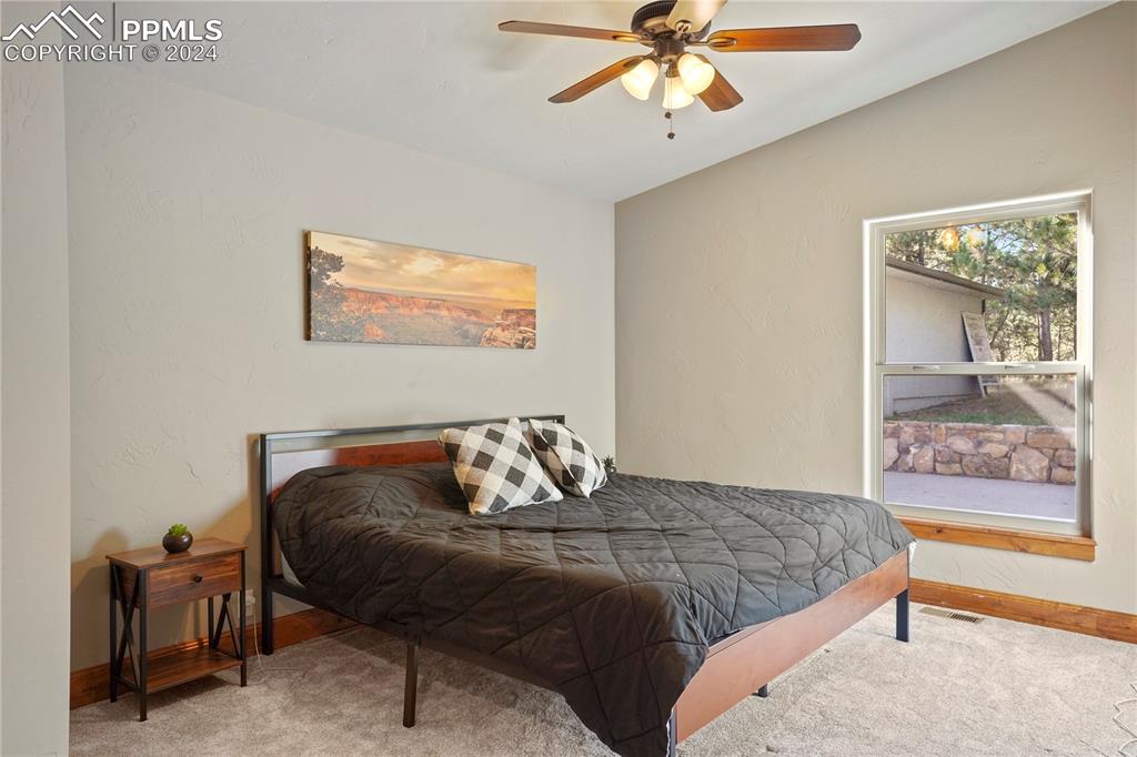 9450 Morgan Road Colorado Springs, CO 80908 - Photo 34 of 49 a bedroom with a bed and balcony
