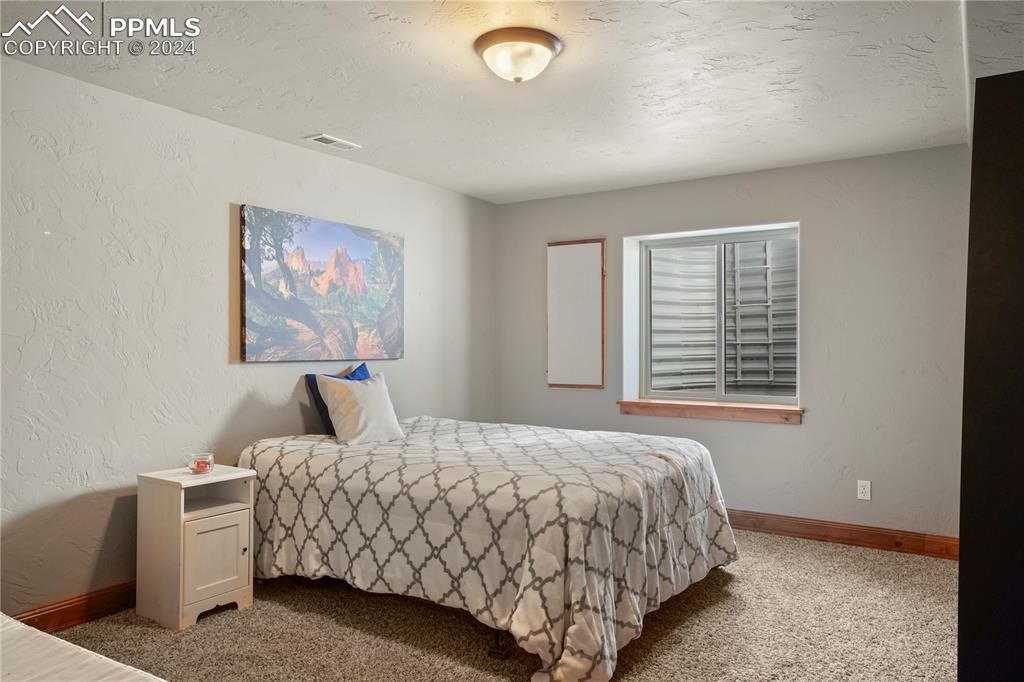9450 Morgan Road Colorado Springs, CO 80908 - Photo 39 of 49 a bedroom with a bed and a window