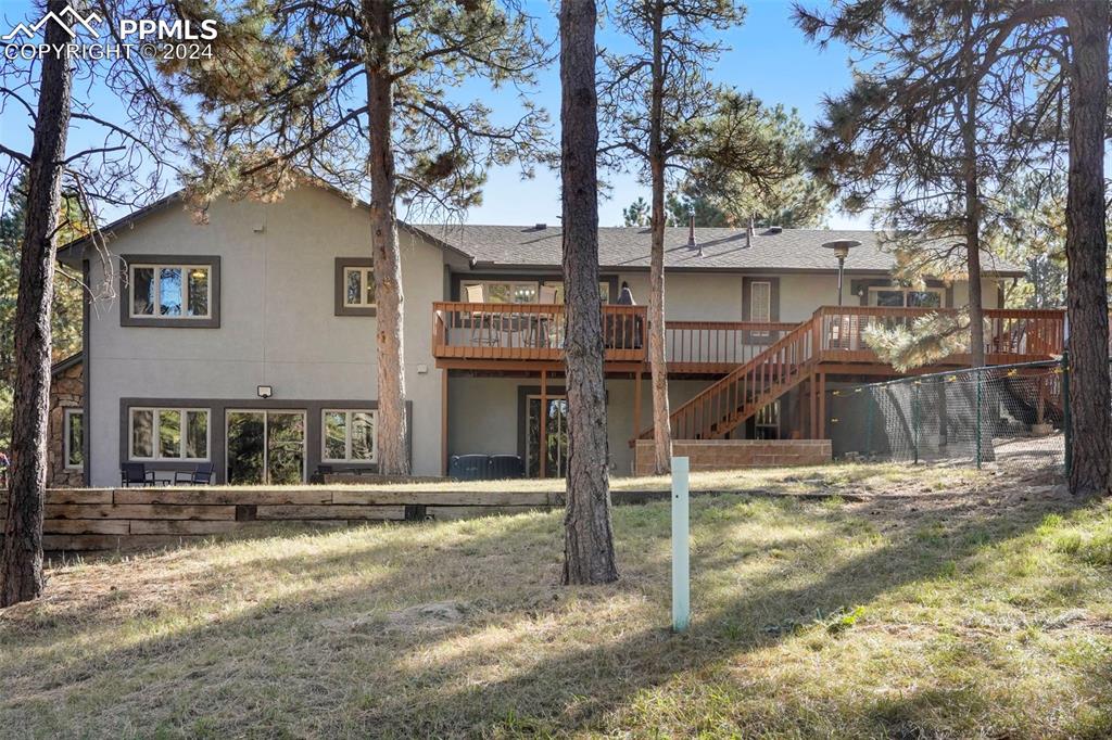 9450 Morgan Road Colorado Springs, CO 80908 - Photo 5 of 49 a house with trees in front of it