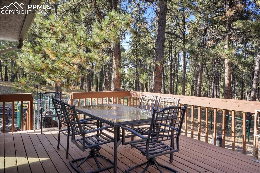 9450 Morgan Road Colorado Springs, CO 80908 - Photo 9 of 49 a patio with table and chairs and wooden floor