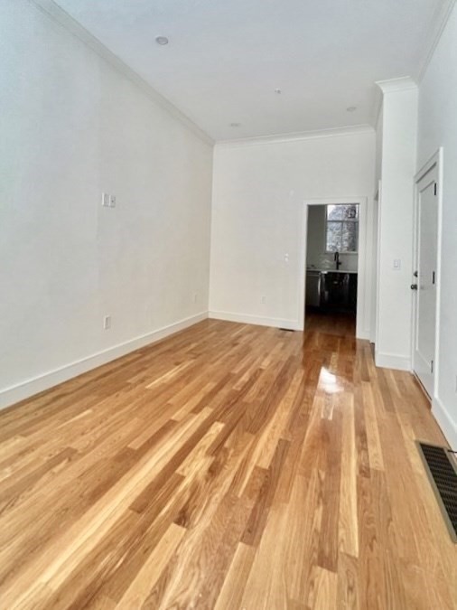 18 Grove Street, Unit 1 Boston, MA 02114 - Photo 4 of 13 a view of a room with wooden floor and a sink