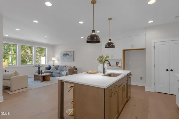 a kitchen with kitchen island a sink and a large window