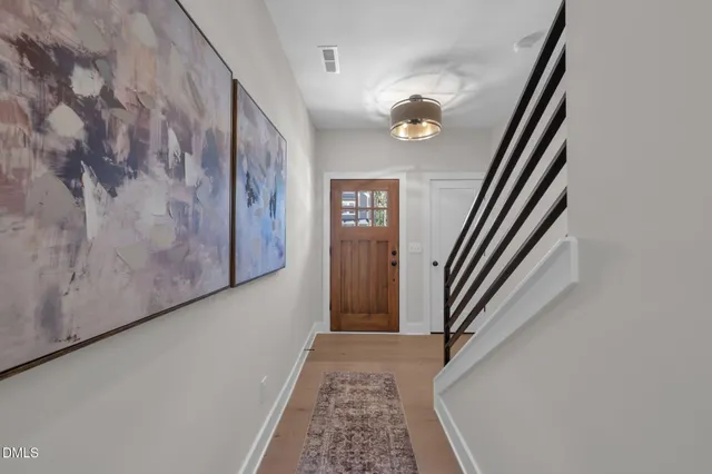 a living room with furniture and view of kitchen