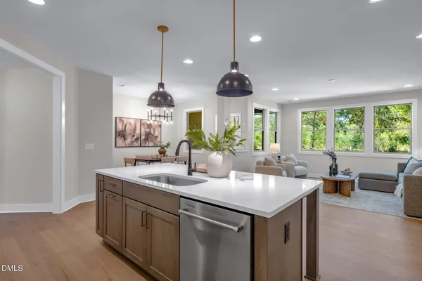 a living room with furniture and view of kitchen