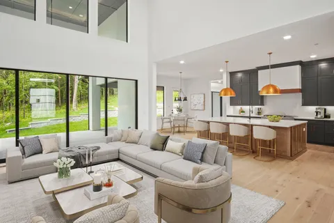 a view of kitchen with kitchen island wooden floor and window