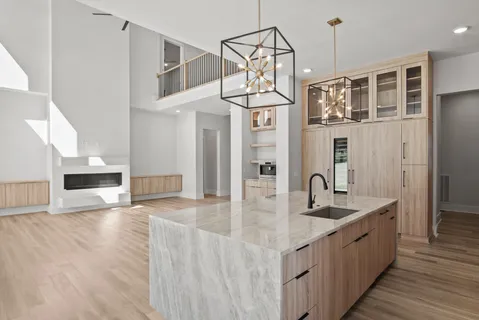 a view of kitchen with refrigerator microwave and stove