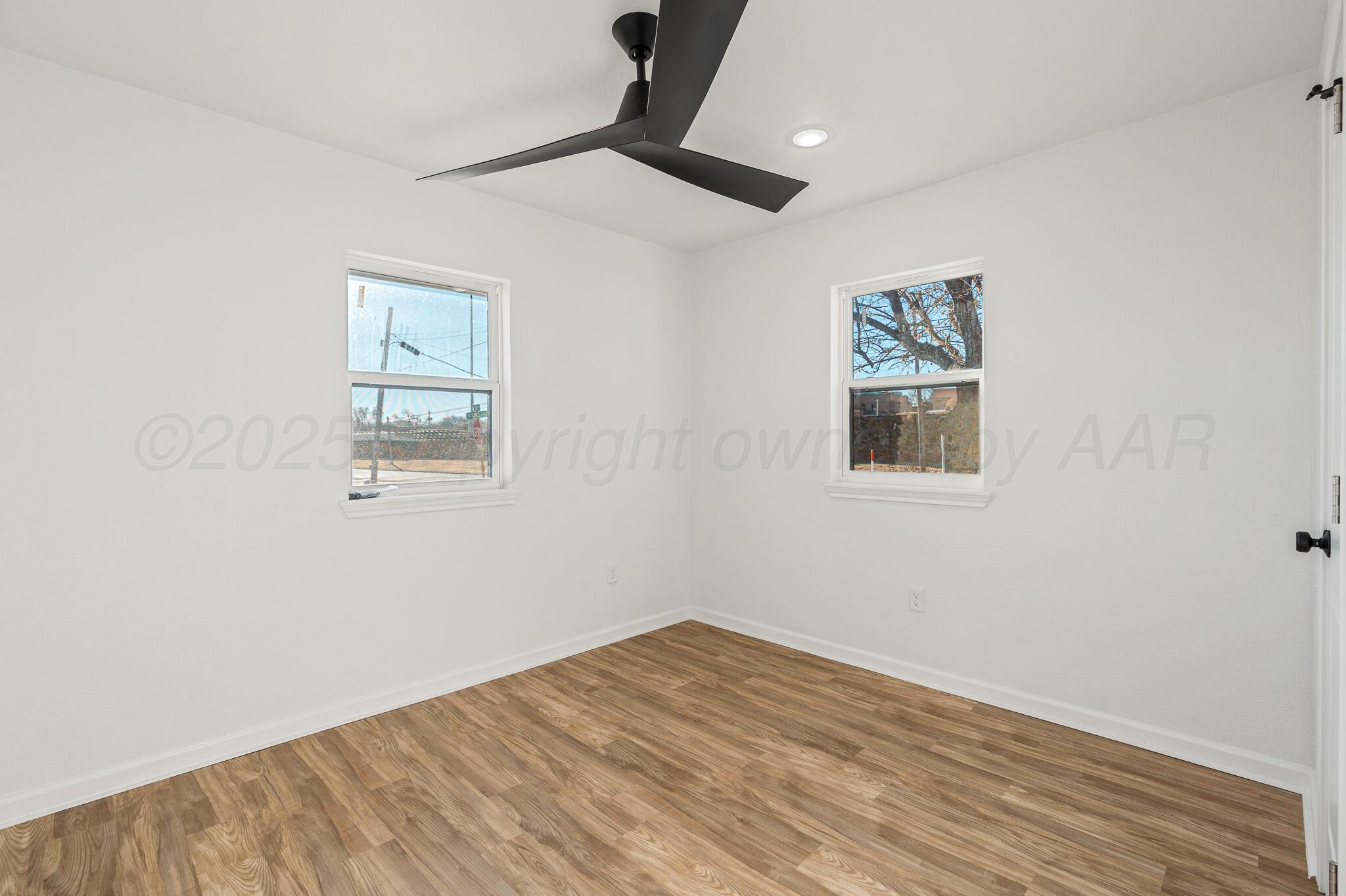 220 Sims Street Clarendon, TX 79226 - Photo 15 of 17 a view of empty room with wooden floor