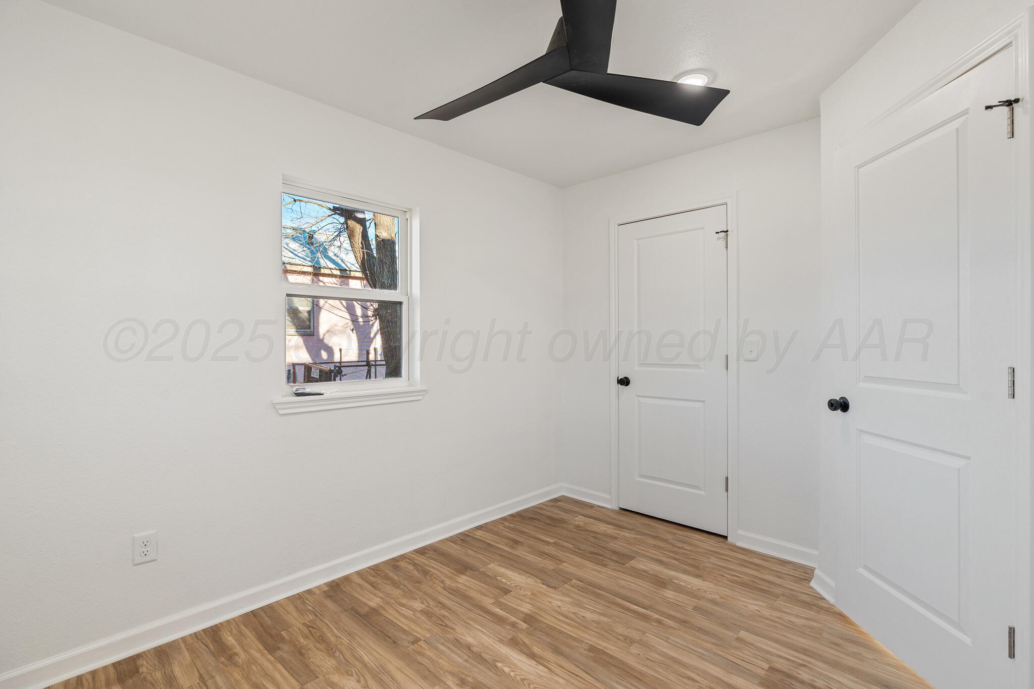 220 Sims Street Clarendon, TX 79226 - Photo 16 of 17 a view of empty room with wooden floor and fan