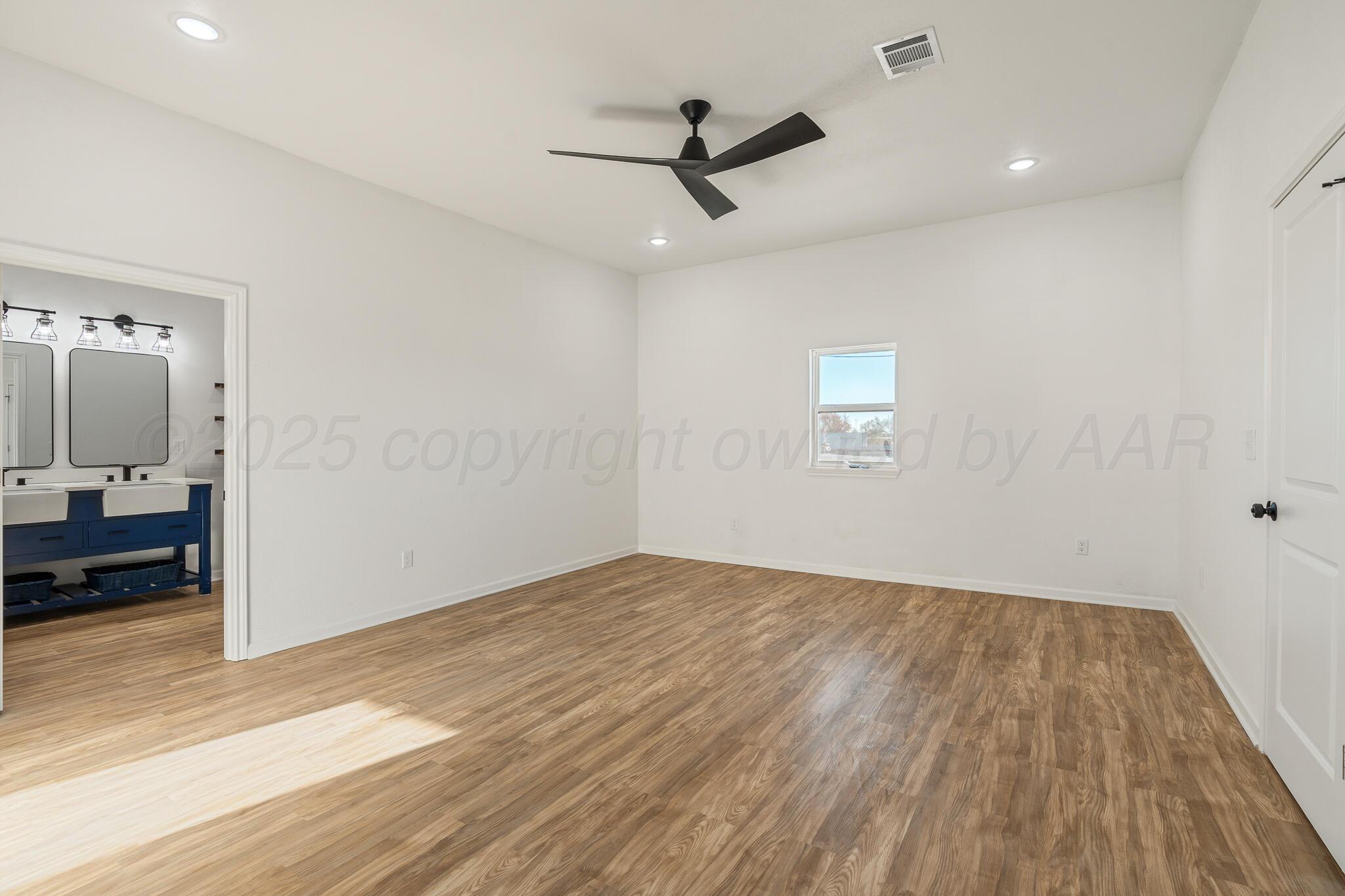 220 Sims Street Clarendon, TX 79226 - Photo 9 of 17 a view of a livingroom with wooden floor and a ceiling fan