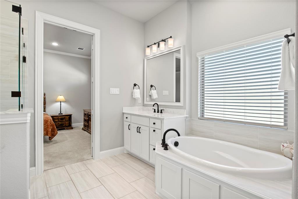 2002 Kati Jane Lane Midlothian, TX 76065 - Photo 11 of 30 a bathroom with a tub a sink a mirror and a shower