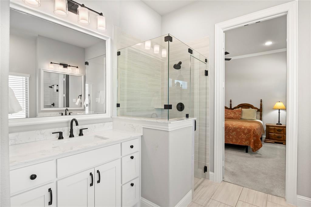 2002 Kati Jane Lane Midlothian, TX 76065 - Photo 12 of 30 a en suite bathroom with a double vanity sink a mirror and a shower