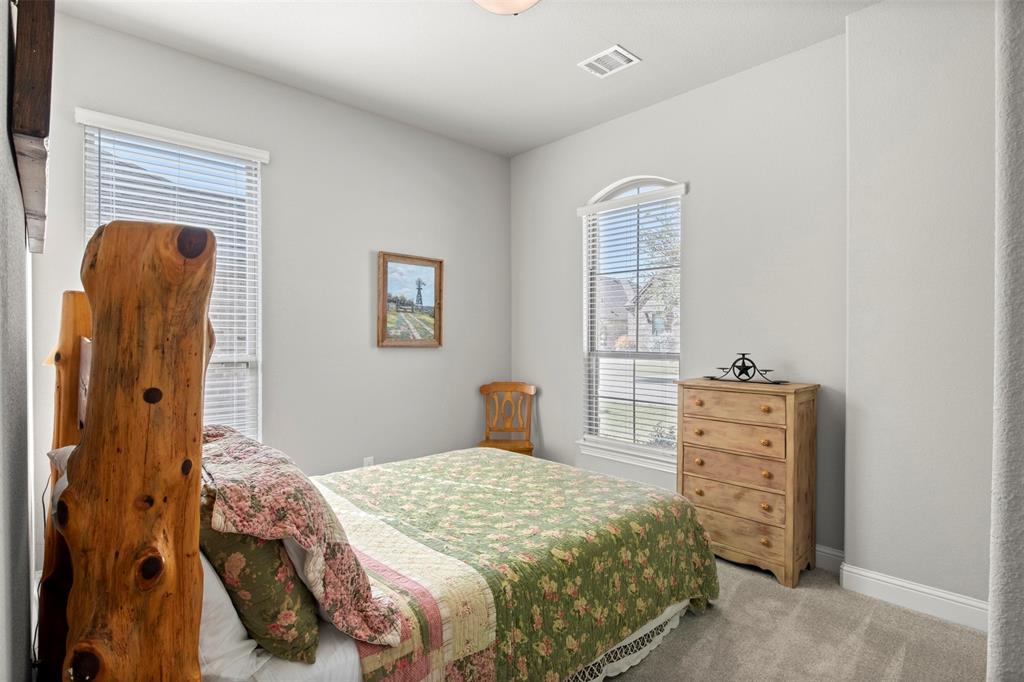 2002 Kati Jane Lane Midlothian, TX 76065 - Photo 13 of 30 a bedroom with a bed and a dresser